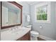 Charming bathroom with a wood vanity, a framed mirror, and a shower at 4405 New Brighton Dr, Apex, NC 27539