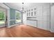Elegant dining room featuring hardwood floors, built-in cabinets, and a stylish chandelier at 4405 New Brighton Dr, Apex, NC 27539