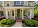 Inviting front porch with white columns, a cozy bench, and tasteful landscaping enhances curb appeal at 4405 New Brighton Dr, Apex, NC 27539
