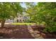 Beautifully landscaped front yard with a stone pathway leading to a charming two-story home with a porch at 4405 New Brighton Dr, Apex, NC 27539