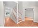 Inviting hallway with hardwood floors, staircase, and natural light at 4405 New Brighton Dr, Apex, NC 27539