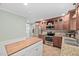 Well-appointed kitchen with stainless steel appliances, granite countertops, and custom wood cabinetry at 4405 New Brighton Dr, Apex, NC 27539