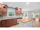 Spacious kitchen featuring custom cabinets, granite countertops, and a convenient kitchen island at 4405 New Brighton Dr, Apex, NC 27539