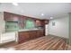 Cozy kitchenette with wooden cabinets, laminate flooring, and essential appliances at 4405 New Brighton Dr, Apex, NC 27539
