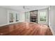 Bright living room with hardwood floors, a stone fireplace, and French doors leading to the outside at 4405 New Brighton Dr, Apex, NC 27539
