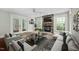 Digitally staged living room with hardwood floors, a stone fireplace, and French doors leading to the outside at 4405 New Brighton Dr, Apex, NC 27539