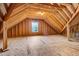 An unfinished attic space with wooden beams and a small window at 494 Mulberry Banks Dr, Clayton, NC 27527