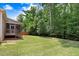 Large backyard with lush greenery and mature trees provides privacy and shade at 494 Mulberry Banks Dr, Clayton, NC 27527