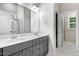 Bright bathroom featuring a double vanity with marble countertop, gray cabinets, and modern fixtures at 494 Mulberry Banks Dr, Clayton, NC 27527