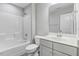 A well-lit bathroom featuring a shower and a vanity with a large mirror at 494 Mulberry Banks Dr, Clayton, NC 27527