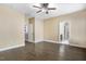 Spacious bedroom with ceiling fan, dark hardwood floors, and an open doorway to the bathroom at 494 Mulberry Banks Dr, Clayton, NC 27527