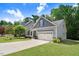 Charming single-Gathering home with a well-manicured lawn, gray shingles, and a two-car garage at 494 Mulberry Banks Dr, Clayton, NC 27527