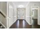 Bright foyer with dark hardwood floors and white trim leads into the home's main living areas at 494 Mulberry Banks Dr, Clayton, NC 27527