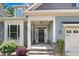 Inviting front entrance with stone accents, well-kept landscaping, and a black front door at 494 Mulberry Banks Dr, Clayton, NC 27527