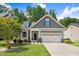 Charming single-Gathering home with a well-manicured lawn, gray shingles, and a two-car garage at 494 Mulberry Banks Dr, Clayton, NC 27527