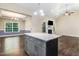 Modern kitchen with granite countertops, island with seating, and view to adjoining dining room at 494 Mulberry Banks Dr, Clayton, NC 27527