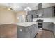 Modern kitchen with granite countertops, stainless steel appliances, gray cabinets, and island at 494 Mulberry Banks Dr, Clayton, NC 27527