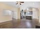 Open-concept living room with wood floors connecting to kitchen with breakfast bar at 494 Mulberry Banks Dr, Clayton, NC 27527