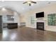 Open concept living area with fireplace, hardwood floors, and lots of natural light at 494 Mulberry Banks Dr, Clayton, NC 27527