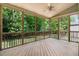 A screened porch features a ceiling fan and views of the green, tree-filled yard at 494 Mulberry Banks Dr, Clayton, NC 27527