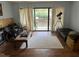 Cozy living room with hardwood floors, a cream rug, sliding glass doors, and a telescope at 500 Umstead # 208D, Chapel Hill, NC 27516