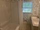 Bright bathroom featuring a bathtub and blue floral wallpaper at 5026 Gatewood Drive Dr, Durham, NC 27712
