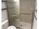 Bright bathroom featuring a tiled shower and safety bar for accessibility at 5026 Gatewood Drive Dr, Durham, NC 27712