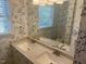 Double sinks set in a bathroom with blue floral wallpaper and a window view at 5026 Gatewood Drive Dr, Durham, NC 27712