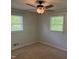 Corner bedroom features two windows, plush carpet, and a ceiling fan at 5026 Gatewood Drive Dr, Durham, NC 27712