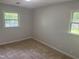 Bright bedroom features neutral carpet and two windows offering ample natural light at 5026 Gatewood Drive Dr, Durham, NC 27712