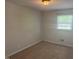 Cozy bedroom with neutral carpet, a window, and updated light fixture at 5026 Gatewood Drive Dr, Durham, NC 27712