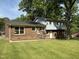 House back shows a brick-based foundation with second story above at 5026 Gatewood Drive Dr, Durham, NC 27712