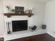 Elegant brick fireplace with a wooden mantel and decorative accents, adding character to the room at 5026 Gatewood Drive Dr, Durham, NC 27712