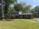 Charming two-story home with brick accents, mature trees, and well-maintained lawn at 5026 Gatewood Drive Dr, Durham, NC 27712