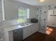 Bright kitchen with white cabinets, stainless steel appliances, and a garden window at 5026 Gatewood Drive Dr, Durham, NC 27712