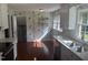 Charming kitchen boasts hardwood floors, granite counters, and blue floral wallpaper at 5026 Gatewood Drive Dr, Durham, NC 27712