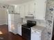 Functional kitchen with white appliances, ample counter space, and plenty of cabinet storage at 5026 Gatewood Drive Dr, Durham, NC 27712