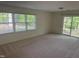 Spacious living room with large window and sliding glass door to the outside at 5026 Gatewood Drive Dr, Durham, NC 27712