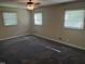Spacious main bedroom with plush carpet, updated windows, and a ceiling fan at 5026 Gatewood Drive Dr, Durham, NC 27712