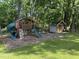 A charming playground with swings, slide, and playhouse for to play at 5026 Gatewood Drive Dr, Durham, NC 27712