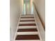 Wooden stairs with white risers and matching hand rail at 5026 Gatewood Drive Dr, Durham, NC 27712
