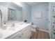 Bathroom featuring white cabinetry, a framed mirror, updated fixtures, and light blue walls at 53 Forest Oaks Dr, Durham, NC 27705