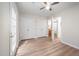 Bedroom featuring wood floors, a ceiling fan, and access to an ensuite bathroom and a private patio at 53 Forest Oaks Dr, Durham, NC 27705