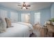 Bright bedroom with an ensuite bathroom, hard wood floors, white trim, and neutral bedding at 53 Forest Oaks Dr, Durham, NC 27705
