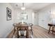 Bright dining area with natural light, a rustic table, and an open view to the kitchen at 53 Forest Oaks Dr, Durham, NC 27705