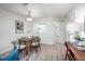 Cozy dining area adjacent to the kitchen, featuring a rustic wood table, and views into kitchen at 53 Forest Oaks Dr, Durham, NC 27705