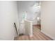 Bright hallway with hardwood floors leading to upper level with vaulted ceilings at 53 Forest Oaks Dr, Durham, NC 27705