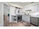 Kitchen features stainless steel appliances, light cabinets and countertops, and an open breakfast bar at 53 Forest Oaks Dr, Durham, NC 27705