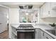 Modern kitchen with stainless appliances and a breakfast bar open to the living area at 53 Forest Oaks Dr, Durham, NC 27705