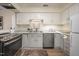Well-lit kitchen with stainless steel appliances, light countertops, and ample storage at 53 Forest Oaks Dr, Durham, NC 27705
